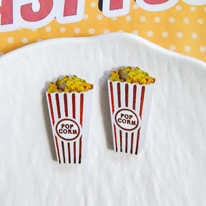 Macro detail of acrylic popcorn charms with red and white stripes for DIY jewelry making
