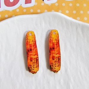 Detail of realistic corn-shaped acrylic charms for DIY earrings and jewelry making