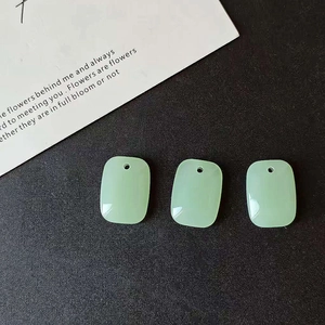 Macro detail of three light green rectangular resin pendants for DIY jewelry making