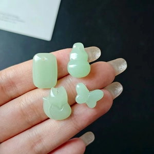 Green resin charms in gourd, fox, and butterfly shapes for DIY jewelry making