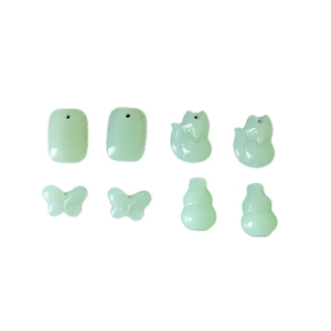 Light green resin charms in butterfly and fox shapes for DIY jewelry making