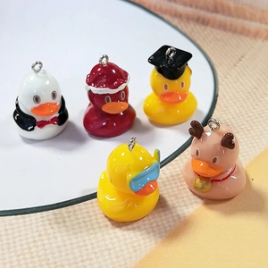 Detailed view of mini resin duck charms including graduation and Christmas themes