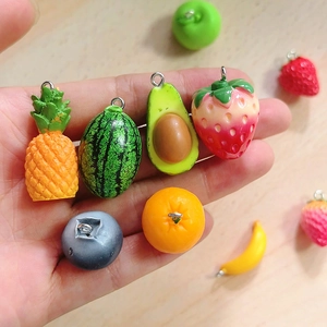 DIY colorful resin fruit pendants including pineapple and strawberry charms for jewelry
