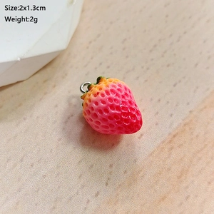Detailed macro view of a 2x1.3cm pink strawberry resin pendant with metal ring loop