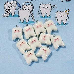 Detailed view of ten cute resin tooth charms with smiling faces for DIY jewelry making