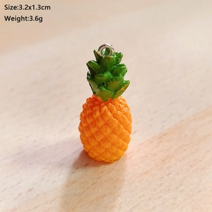 Macro shot of resin pineapple pendant with silver loop, size 3.2x1.3cm and 3.6g weight