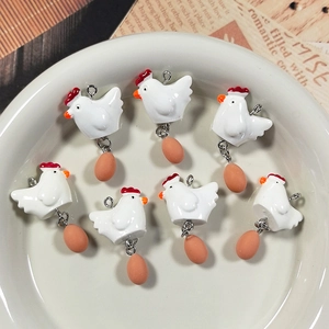 Detailed view of seven creative resin hen and egg charms for DIY jewelry making and crafts