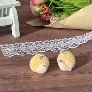 Detailed view of yellow flocked hedgehog charms for DIY jewelry and keychain accessories