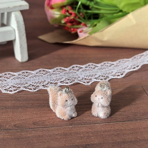 Detailed view of flocked squirrel charms with metal rings for DIY jewelry and crafts