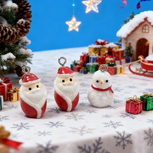 Three cute resin Christmas charms featuring Santa and a snowman with silver hanging loops