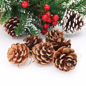 Close-up of natural pine cone Christmas ornaments with golden string and winter decor