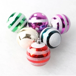 Detail of colorful Christmas ornaments with shiny finishes and silver glitter stripes