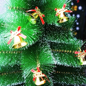 Christmas tree ornaments featuring gold bells, red bows and Merry Christmas lettering