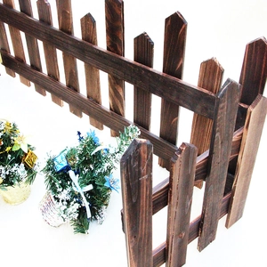 Dark brown solid wood garden fence with carbonized texture for Christmas decor