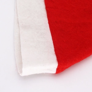Close-up of red non-woven Christmas hat with white felt border stitching details