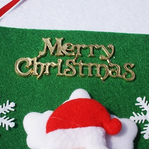 Close-up of felt Merry Christmas bunting with Santa Claus and snowflake decorations