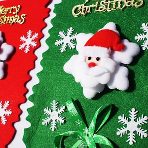 Detail of felt Christmas hanging flag with plush Santa Claus and Merry Christmas text