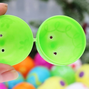 Green plastic openable Easter egg with inner texture detail and colorful background