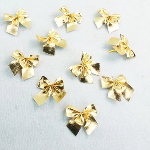 Close-up of ten small golden metallic bows for Christmas tree and gift decoration