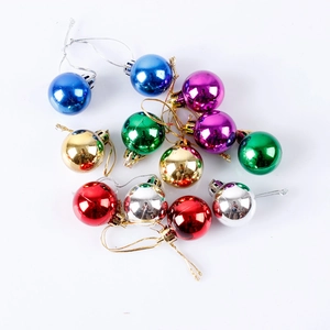 Macro detail of shiny electroplated Christmas balls in various colors with hanging strings