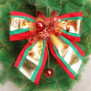 Large red and green Christmas bow with gold ribbons, pine cones and shiny ornaments