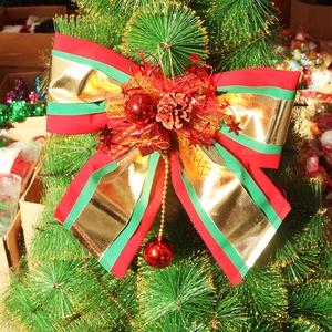 Detailed Christmas tree bow with pine cones and red ornaments on green branches