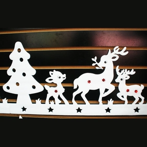 Detail of white foam reindeer family and Christmas tree silhouette window decoration
