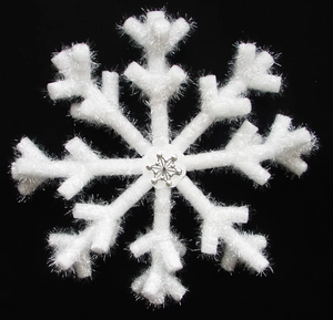 White Christmas snowflake hanging ornament with sparkling center on black background