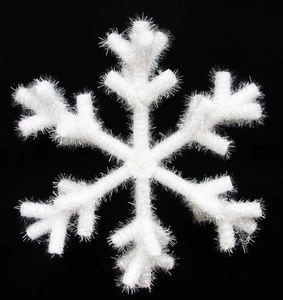 Detail of white plush snowflake ornament with sparkling silver tinsel on black background