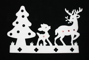 Close-up of white foam Christmas tree and reindeer hanging window decorations