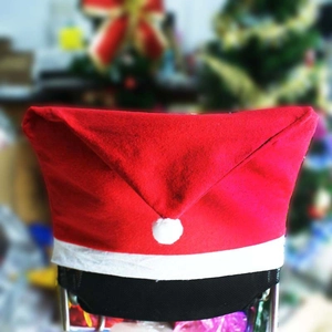 Red non-woven Christmas hat chair cover with white pompom for dining room decor
