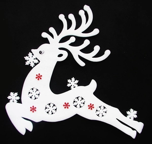 Detail of white foam reindeer Christmas ornament with red snowflake accents on black backdrop