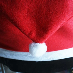 Red felt Christmas hat chair cover with white plush pom pom and fuzzy trim decoration