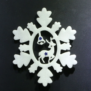 Detailed snowflake Christmas ornament with reindeer and bell motifs on a black background