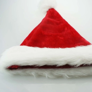 Classic thick red velvet Christmas hat with white plush trim and fuzzy pom pom ball
