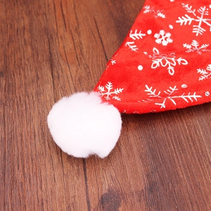 Red velvet Christmas hat with silver snowflake patterns and a soft white plush pompom