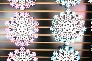Vertical hanging white snowflake ornaments with pink and blue gradient accents for Christmas