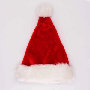 Classic red plush Christmas hat with white faux fur trim and pompom on white background