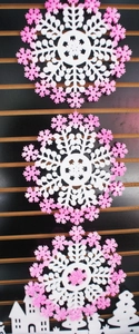 Glittery white snowflake hanging decoration with pink accents and miniature winter scene