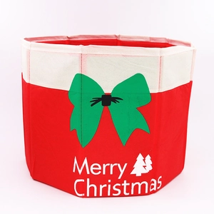 Detail of red and white Merry Christmas felt tree box with a green bow pattern