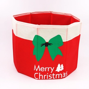 Foldable red Christmas tree base box with Merry Christmas text and green bow pattern