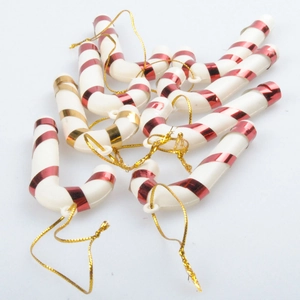 Close-up of red and gold spiral striped candy cane ornaments with golden hanging loops