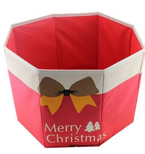 Octagonal red Christmas tree box with festive bow and Merry Christmas text detail