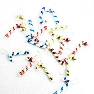 Christmas tree ornaments featuring red, blue and gold plastic candy cane hanging decorations