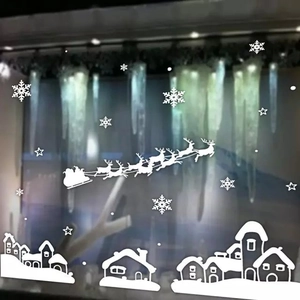 Witte kerstraamstickers met de slee van de Kerstman en diverse sneeuwvlokken