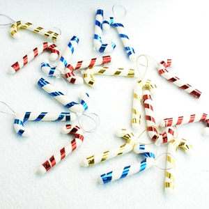 Close-up of 7cm plastic candy cane ornaments with red, blue, and gold metallic stripes