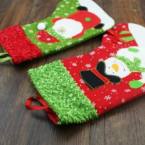 Classic red and green Christmas stockings featuring Santa and snowman embroidery on wood