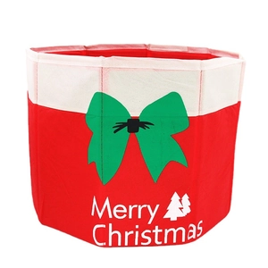 Red Christmas tree base collar with a green bow and Merry Christmas text decor