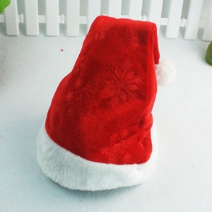 Close-up of red velvet Christmas hat featuring embossed snowflake texture and white plush trim