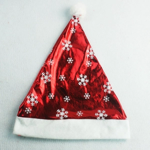 Detail of red metallic Christmas hat with white snowflake patterns and plush fur trim